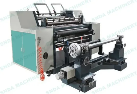 Industrial slitting and rewinding machine with rollers, unwind shaft and teal control cabinet on white background