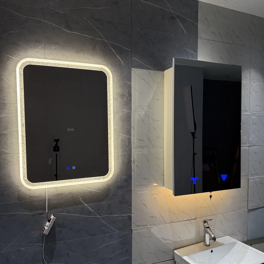 Bathroom wall with matched hardware mirror cabinet and lighting