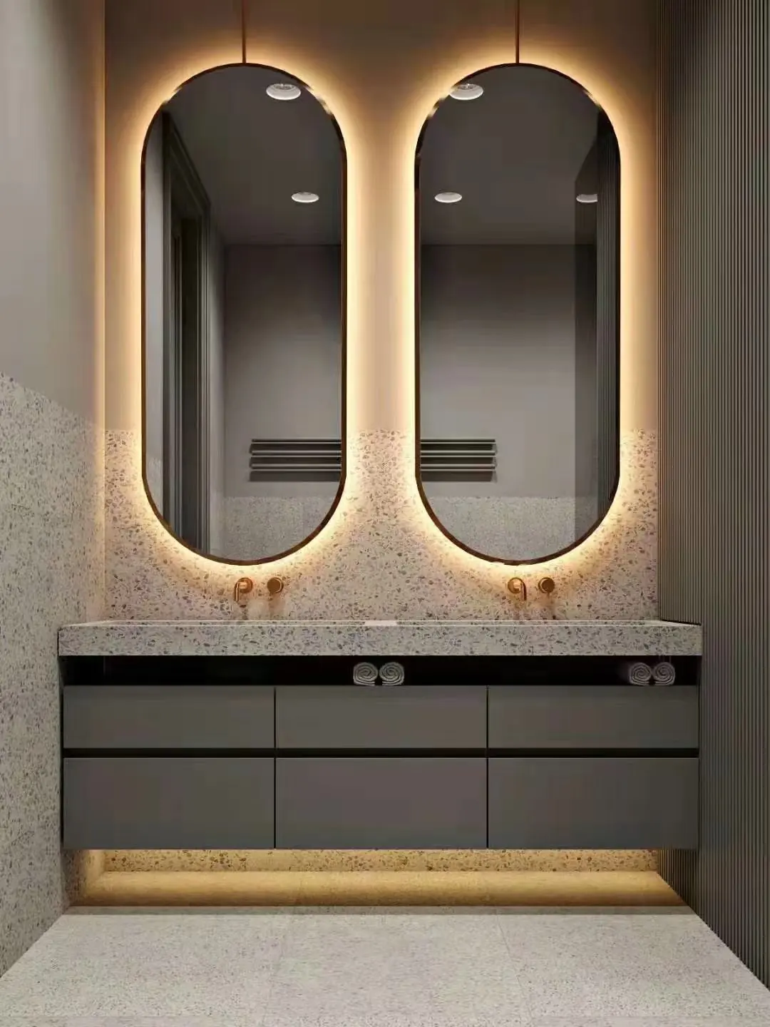 Pair of backlit LED vanity mirrors above a hotel bathroom vanity