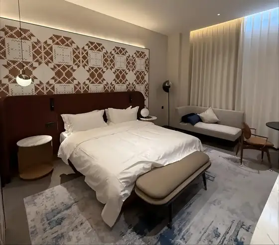 Hotel guest room with patterned carpet and case goods from a Songdom FF and E project