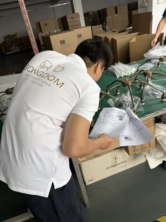Songdom inspector checking a hospitality lamp during factory quality control