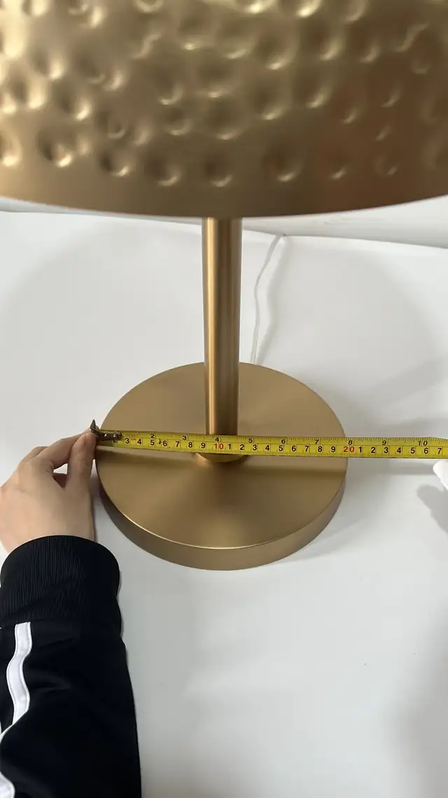Songdom inspector checking a Hotel Indigo table lamp at the factory