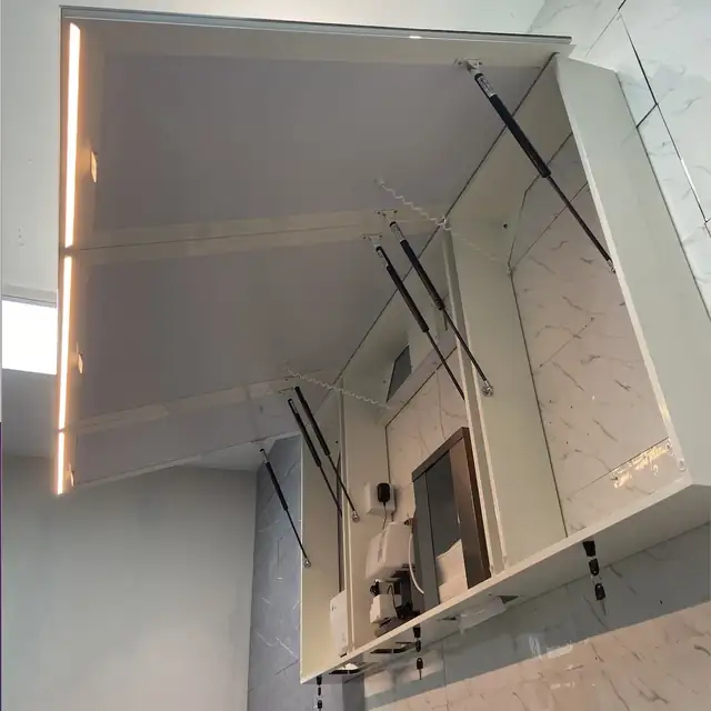 Integrated soap dispenser inside a public washroom mirror cabinet