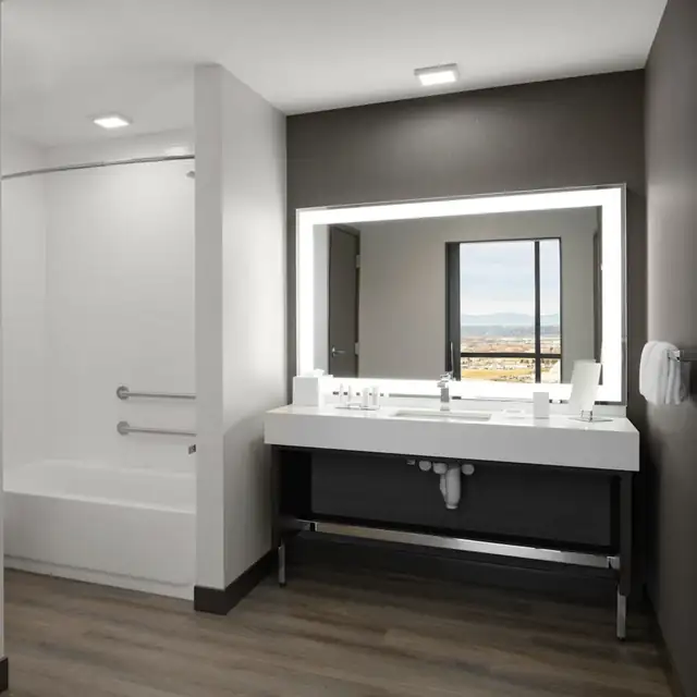 Public washroom vanity with integrated fittings and accessible layout