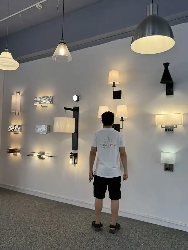 Pendant lamps and wall sconces on display in the Songdom hospitality lighting showroom