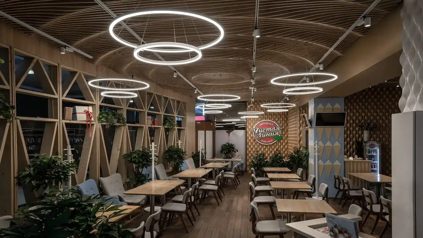 Restaurant interior lit by ring pendant lighting