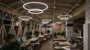 Restaurant interior lit by ring pendant lighting