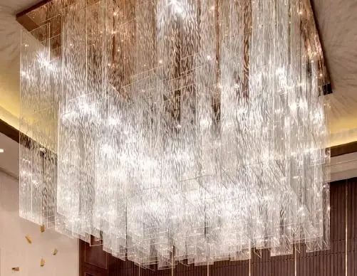 Tempered glass chandelier installed in a tall interior volume