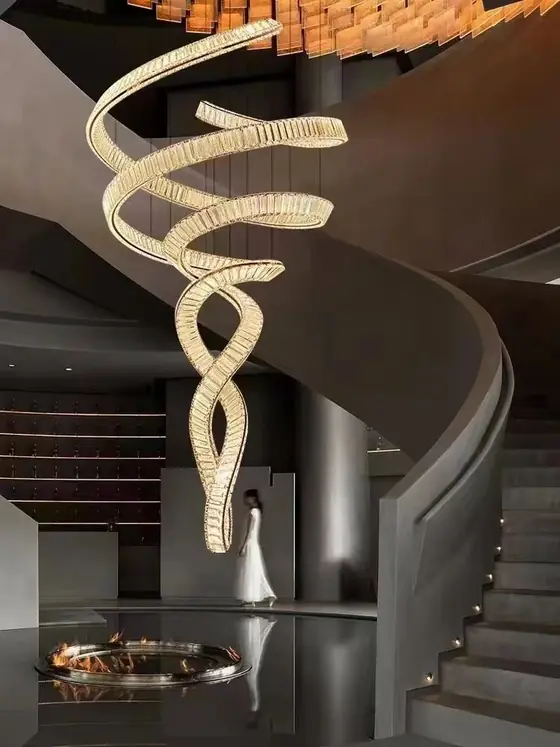 Spiral chandelier in a stair void seen from the ground floor