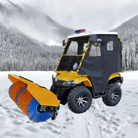 Ride on snow machine shown from the side with working head lowered