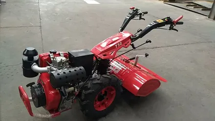Two wheel tractor implement cutting vegetation on a slope