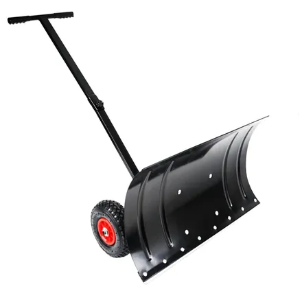 Wheeled snow shovel in use pushing snow on a driveway