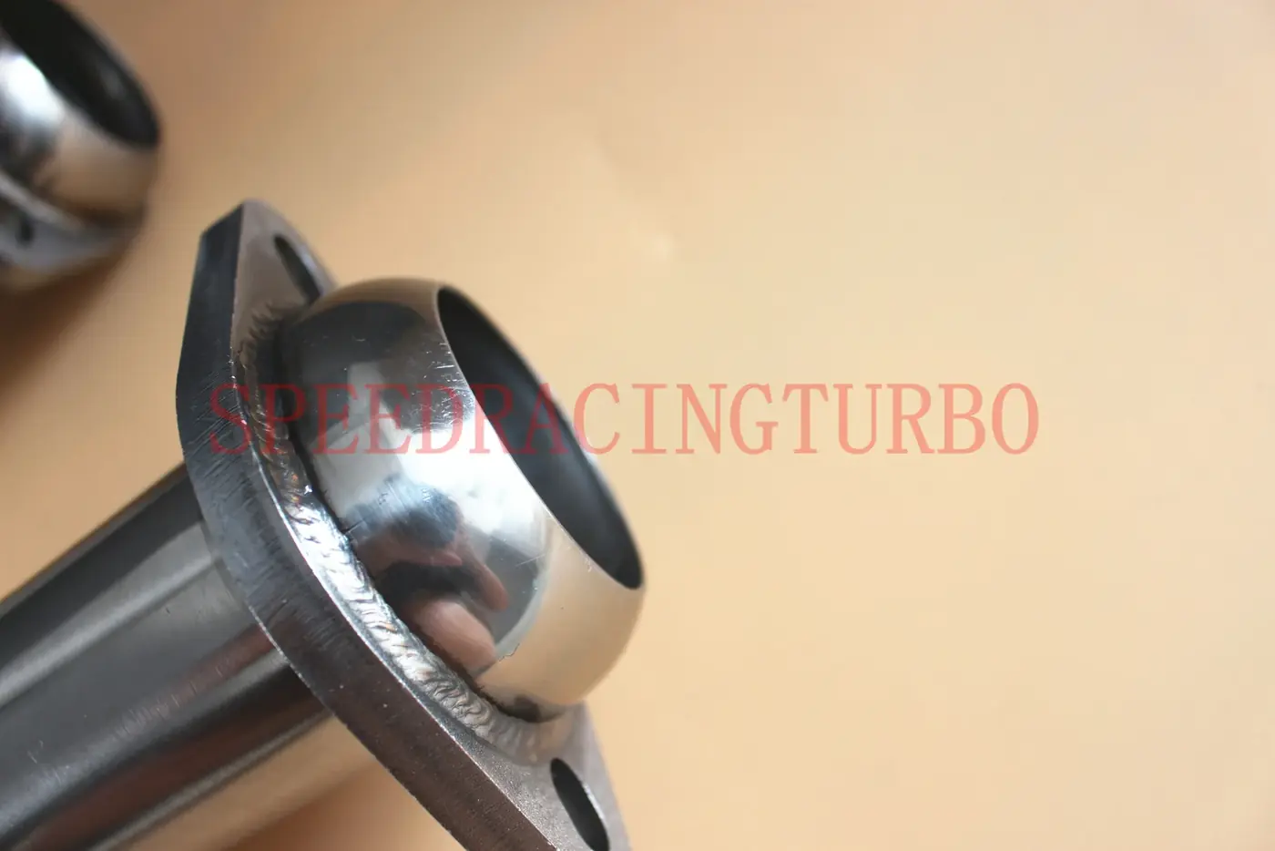 Close-up of V-band flange and included hardware on the exhaust x-pipe