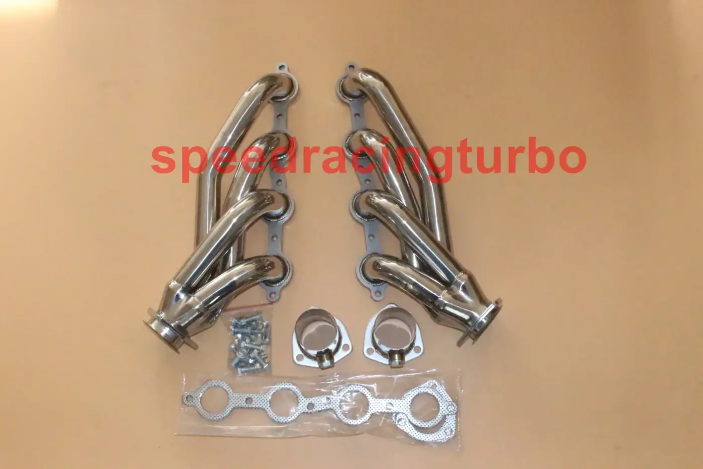 Pair of LS engine swap headers installed on a 1970s Chevrolet C10 with angled spark plug boots