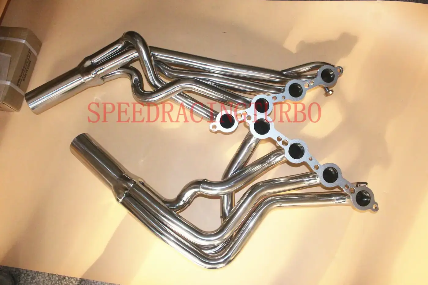 Side view of dual 3 inch exhaust header system with double side TIG welds and stainless steel finish