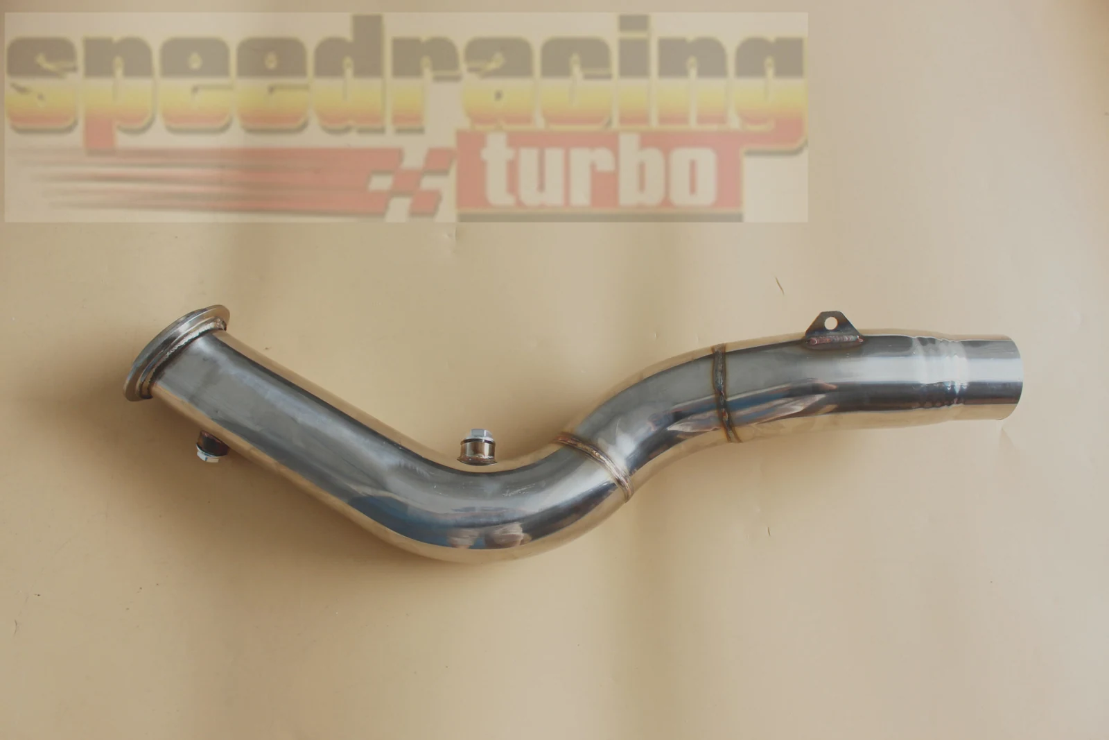 Side view of 3 inch mandrel bent exhaust downpipe with black hardware and TIG weld seams