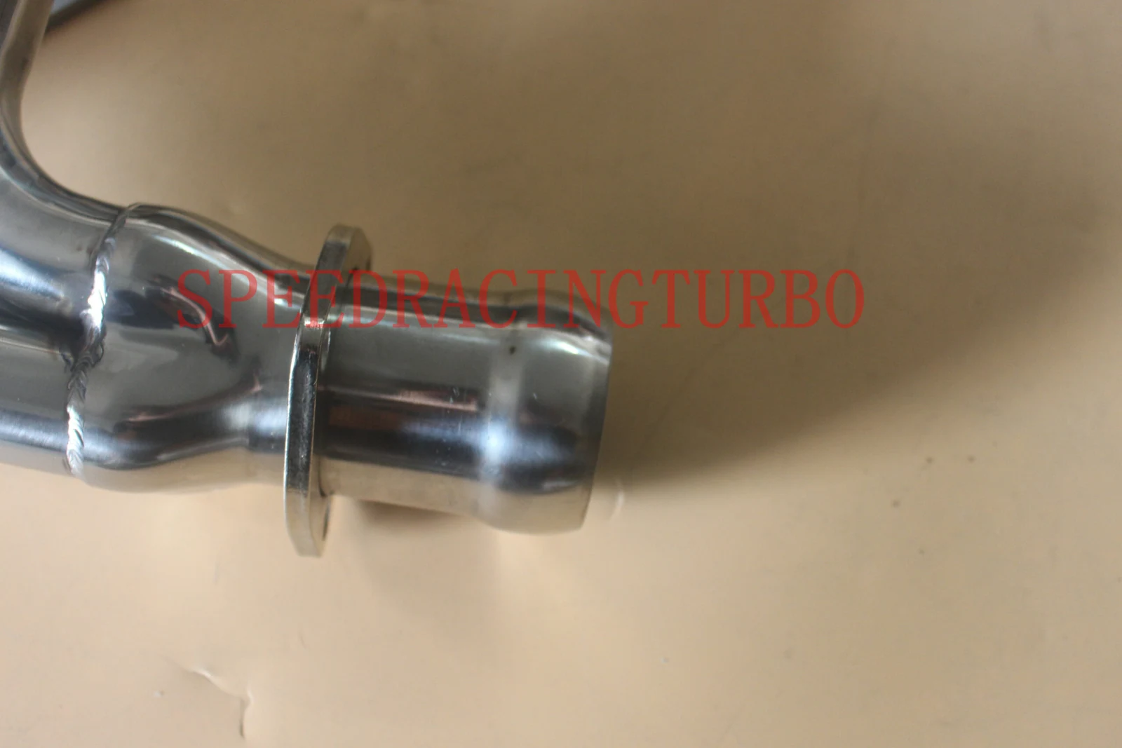 Top view of the header with polished finish and bolt holes