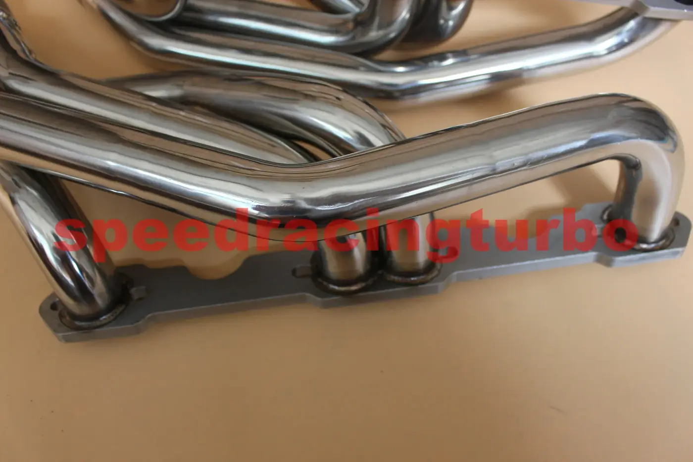 Side view of the header showing primary tube routing and flange alignment