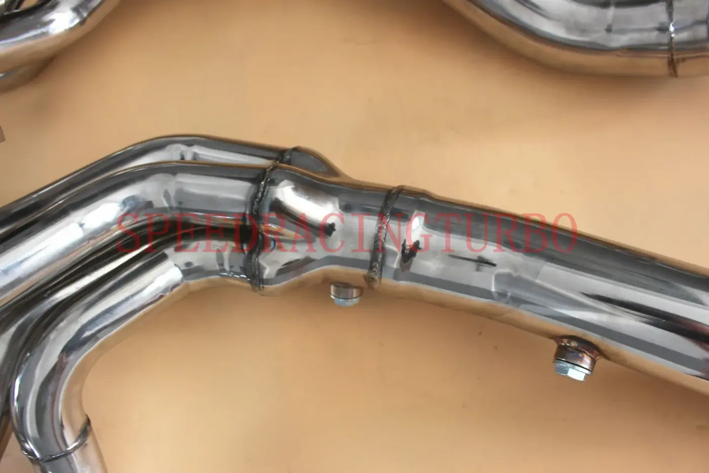 Top view of polished stainless steel header with 3 inch outlet and 8-2-1 primary length design