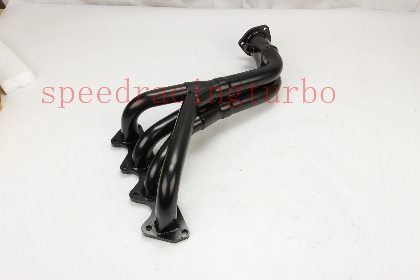 Exhaust header installed on Suzuki Samurai engine with 1.3L and 1.6L L4 cylinder block