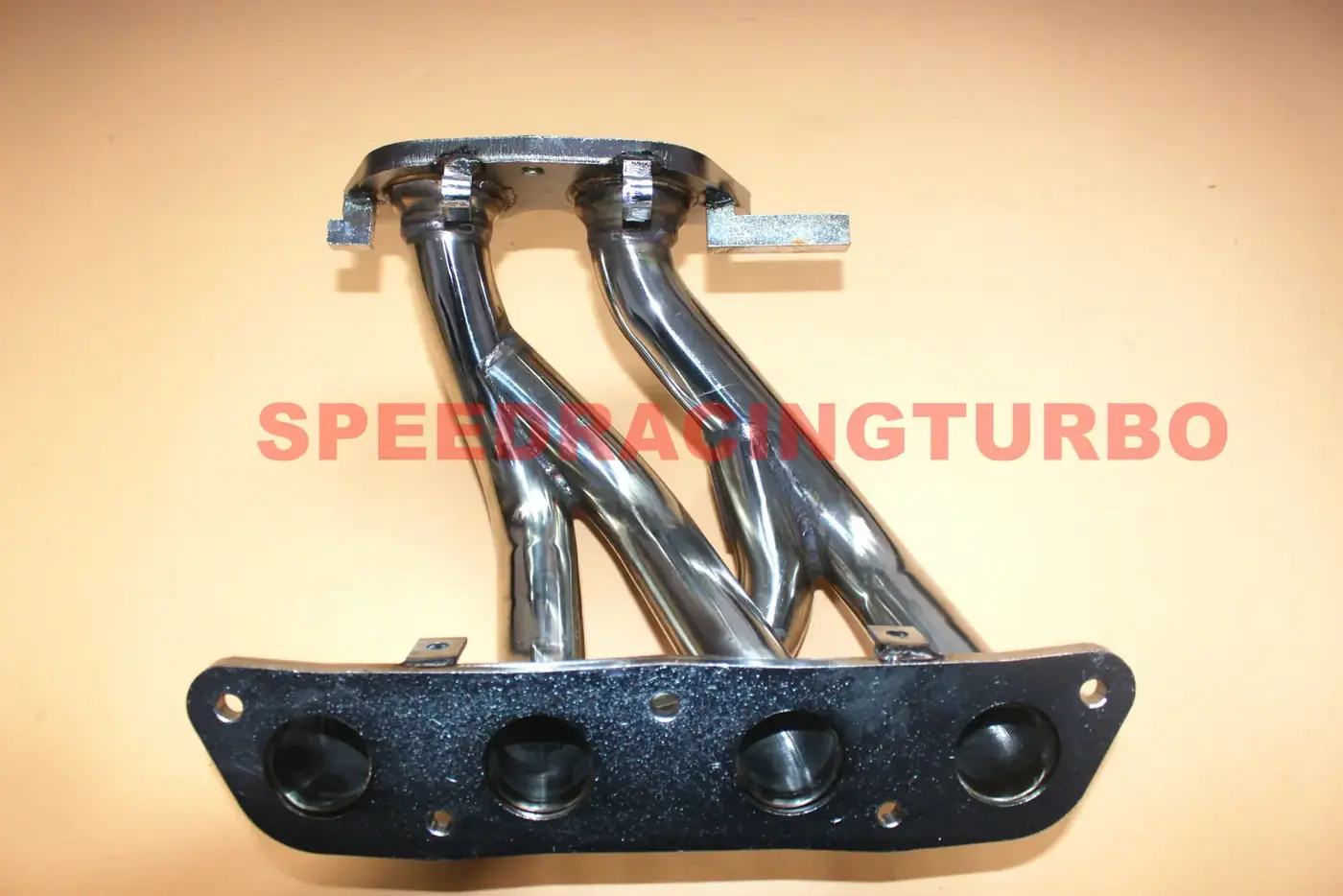 Header installed on MR2 Spyder engine bay with gaskets and hardware visible