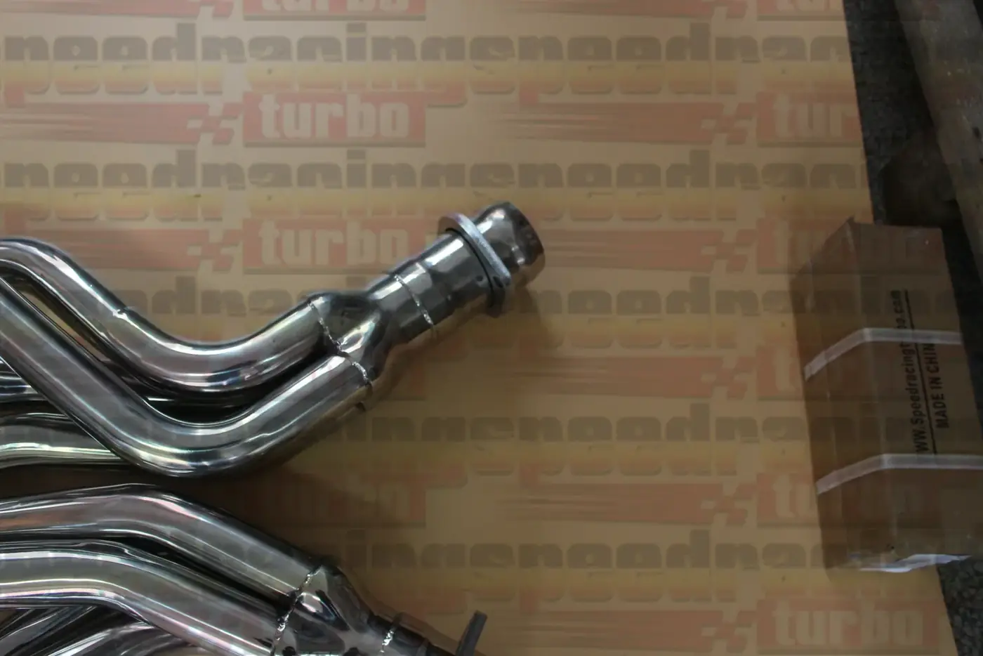 Header installed under a 2014 Dodge Challenger SRT8 showing factory routing