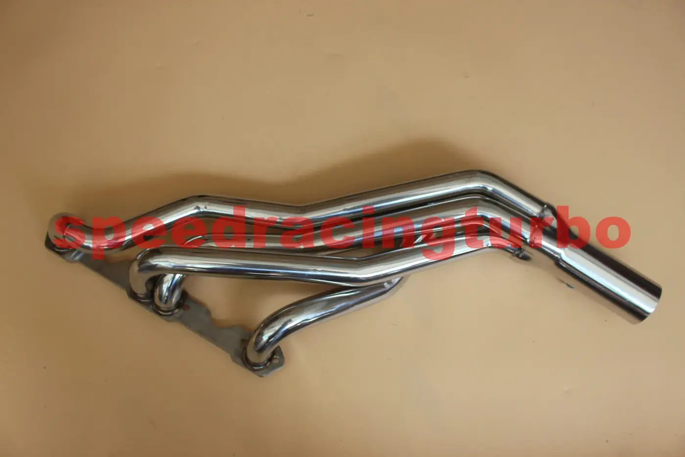 Close-up of polished stainless steel header flanges and Y-pipe connection