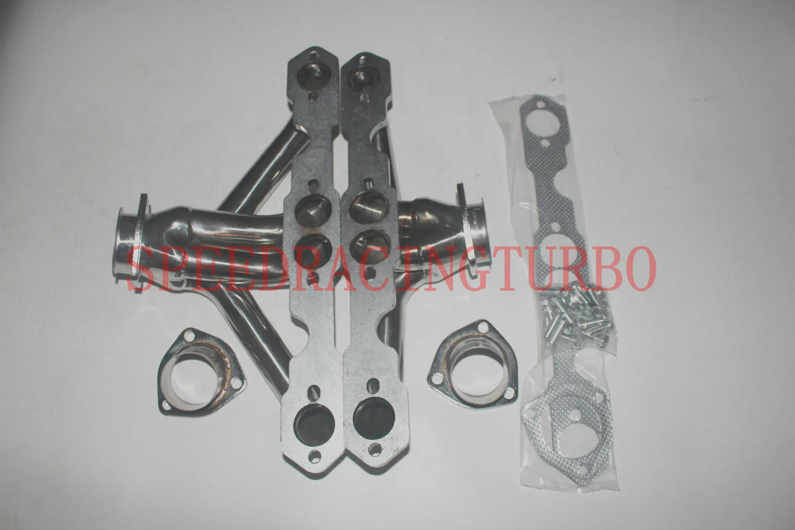Header installed on a 1957 Chevy Small Block engine with original steering box