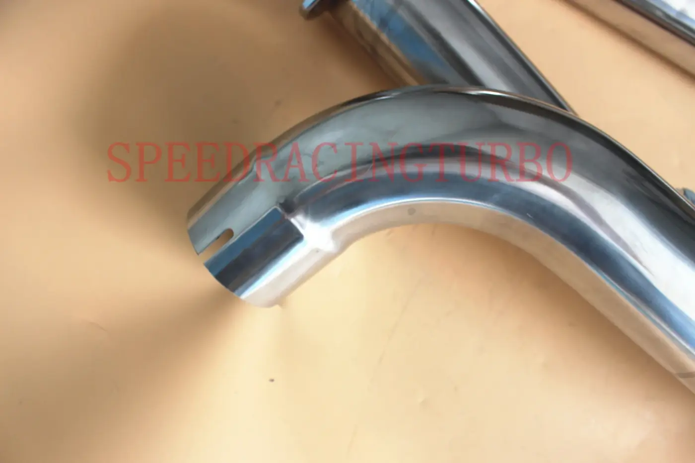 Side view of the Y-pipe showing the 3 inch OD piping and smooth stainless steel finish