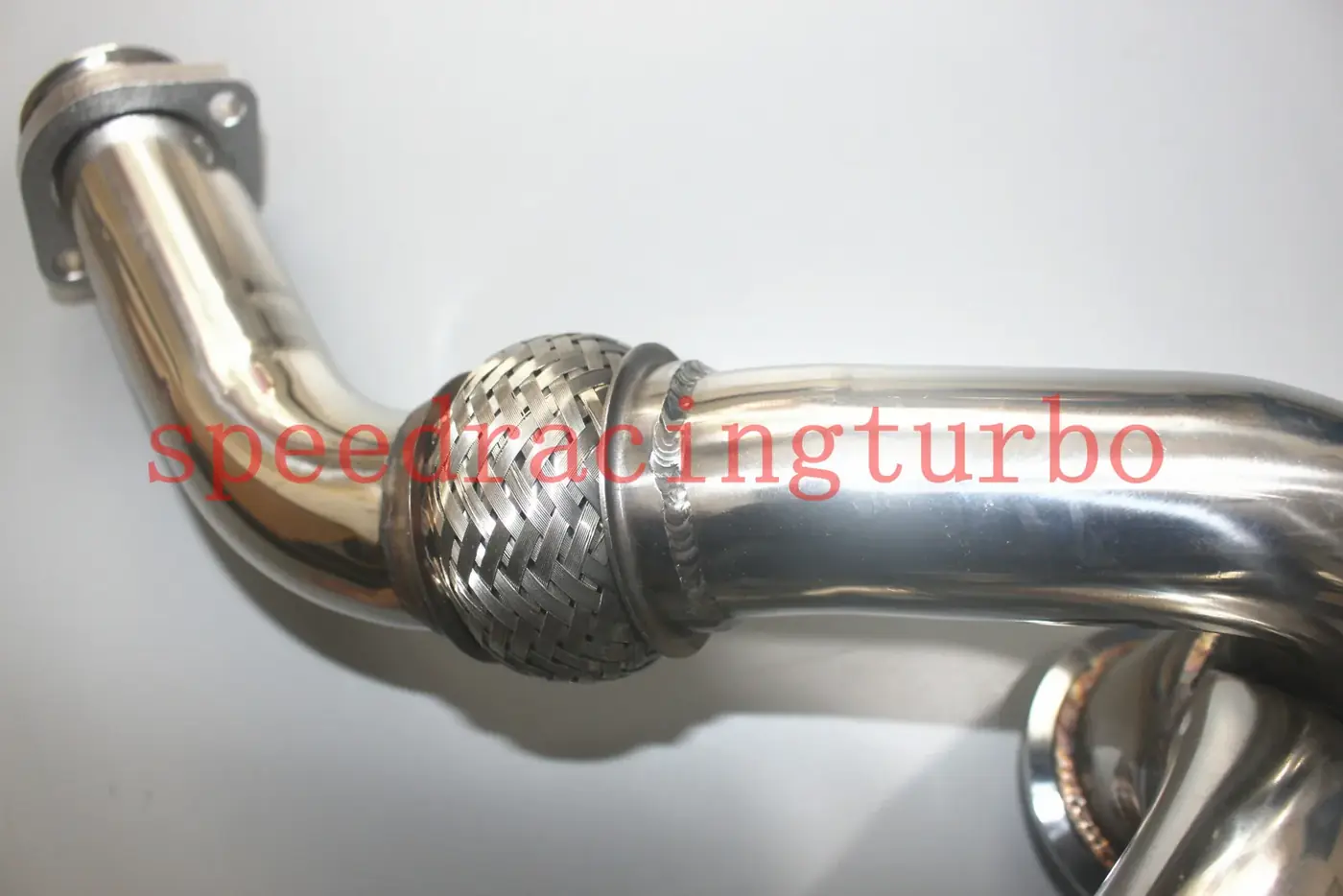 X-pipe with included gasket and mounting hardware laid out on a workbench