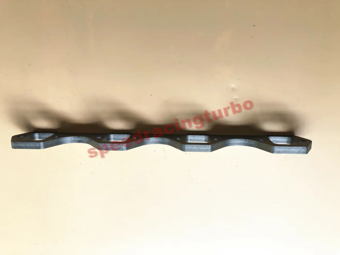 Close-up of 3/8 inch thick stainless steel flange with bolt holes and smooth sealing face