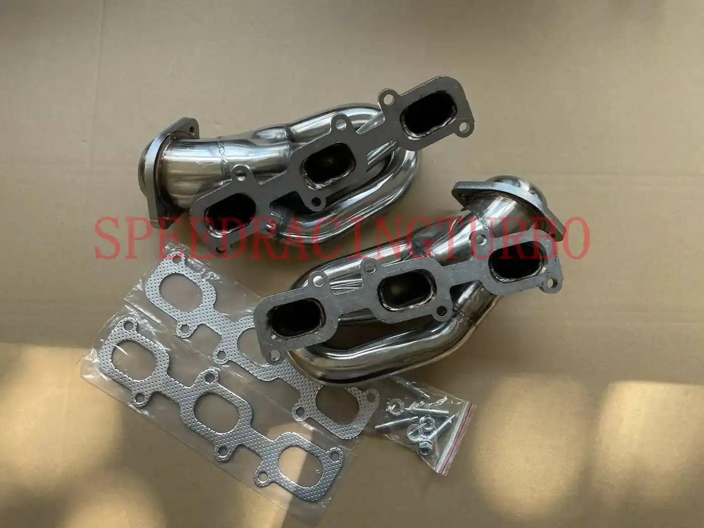 Close-up of CNC machined flange on a T304 stainless exhaust header for Ford Mustang 3.7L V6