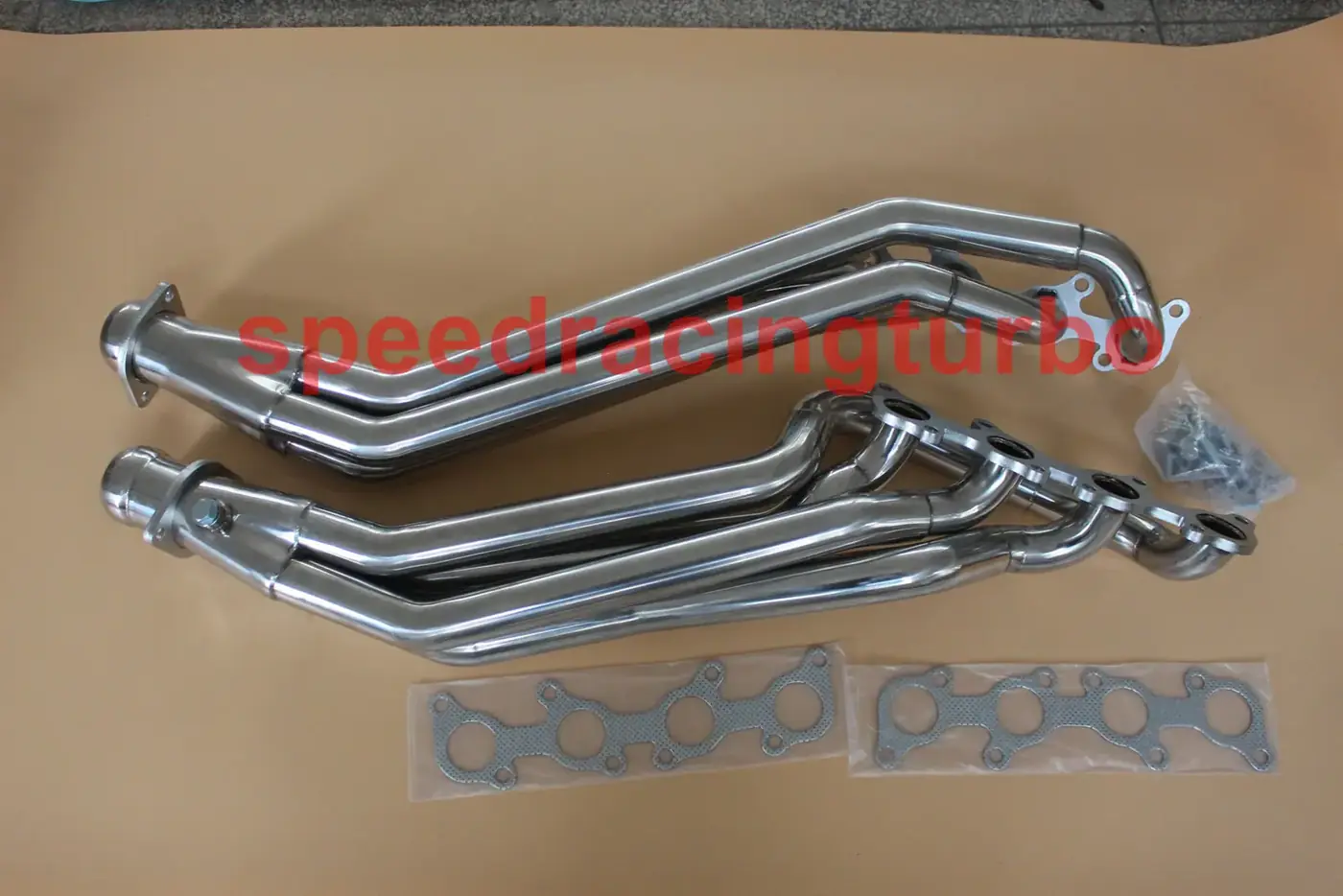 Top view of a long tube header with pre-drilled O2 sensor holes and CNC machined flange