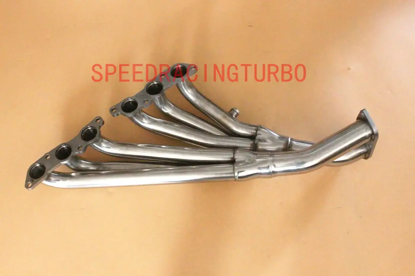 Side view of 3-2 exhaust header showing inlet and outlet ports and mounting points