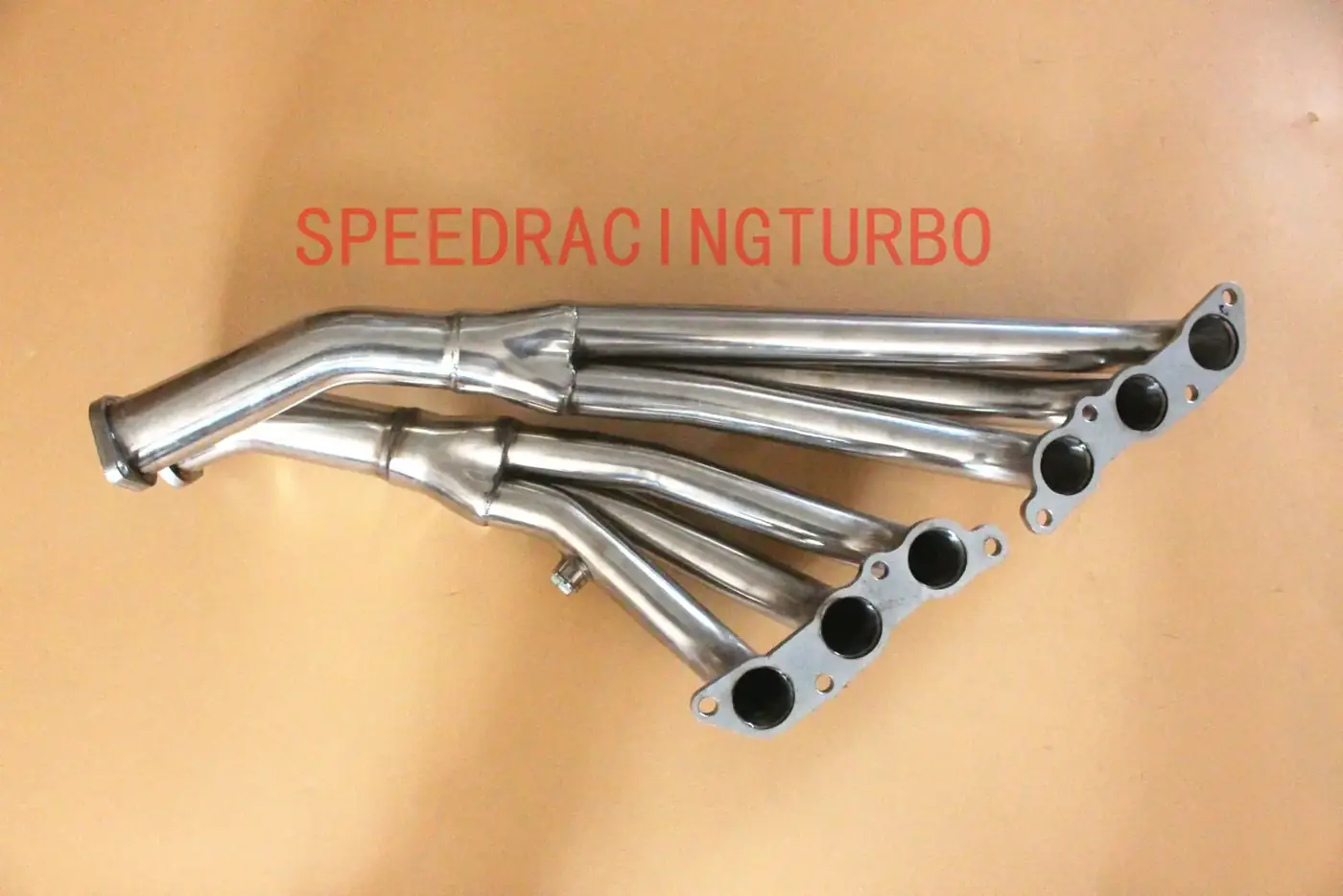Header installed on engine bay showing factory routing and fitment