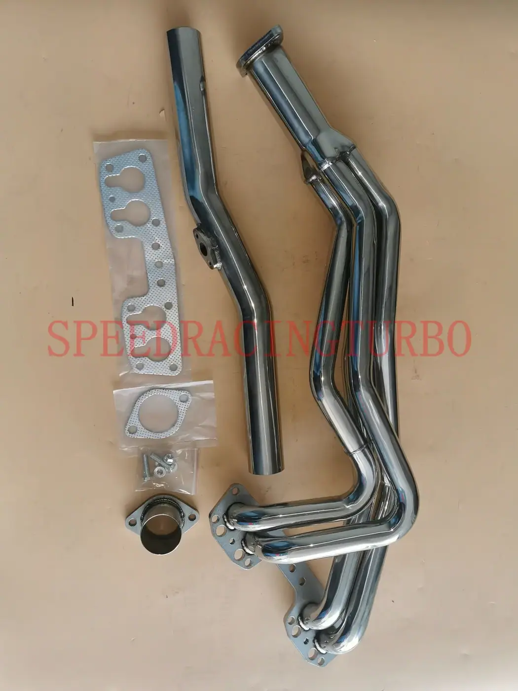 Close-up of CNC machined flanges and TIG/MIG welded joints on the Toyota 2.2L exhaust header
