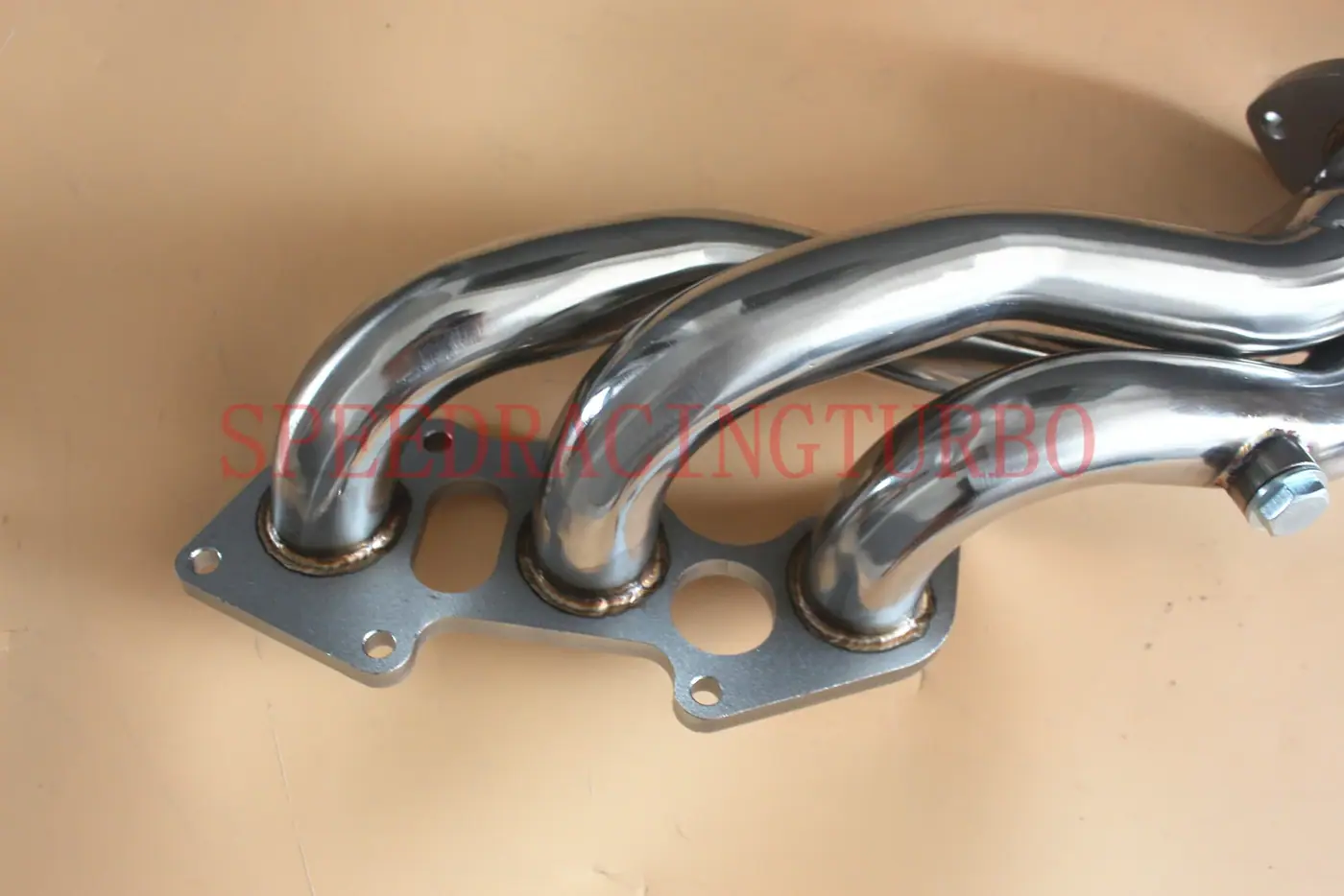 Side view of two exhaust headers with 1.75 inch inlet and 2.25 inch outlet, polished surface