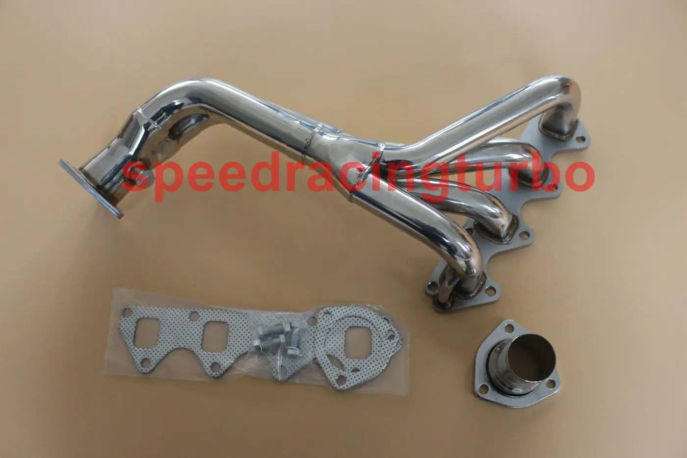 Side view of stainless steel exhaust manifold showing polished finish and flange pattern
