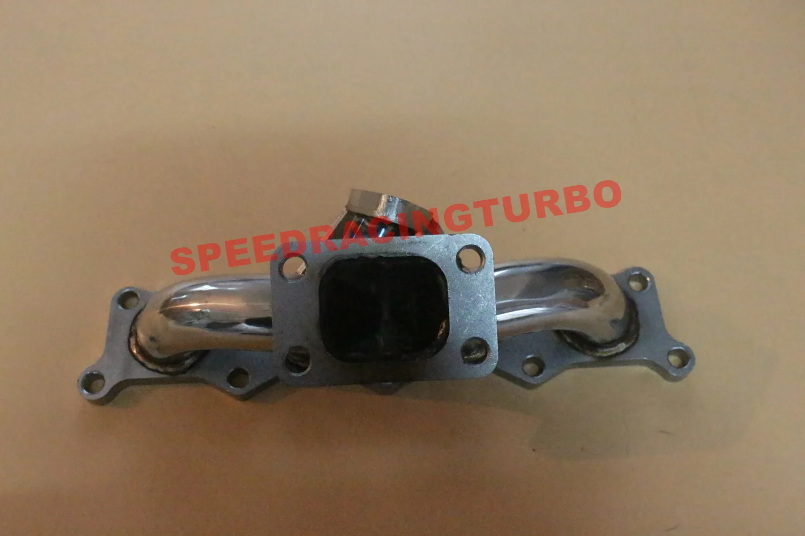 Close-up of CNC machined flange and 38mm/35mm external wastegate port on stainless steel manifold