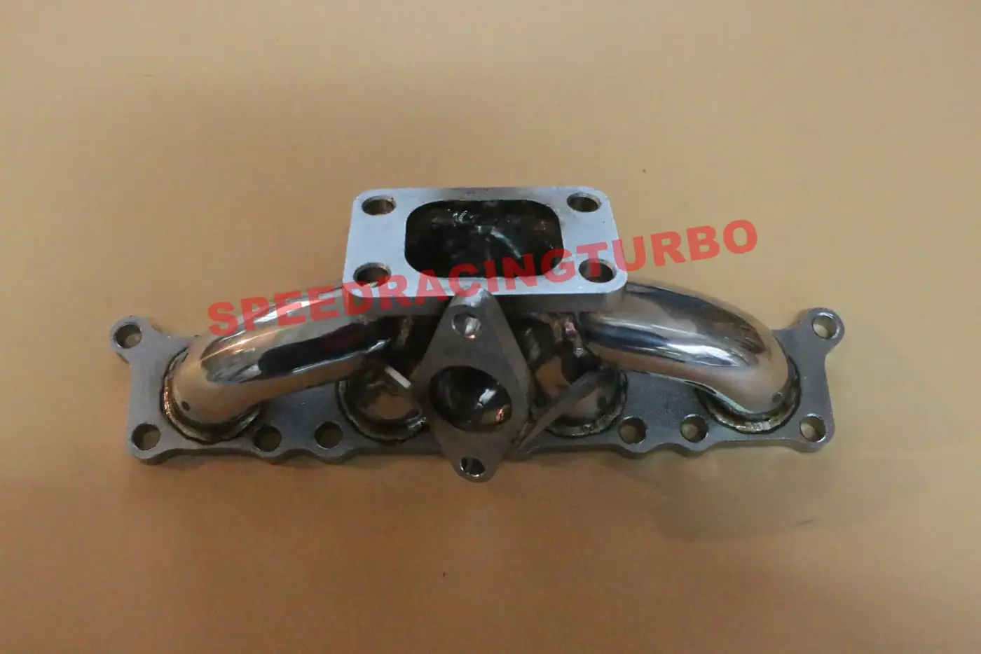 Side view of tubular 304 polished stainless turbo manifold with mandrel bent tubing