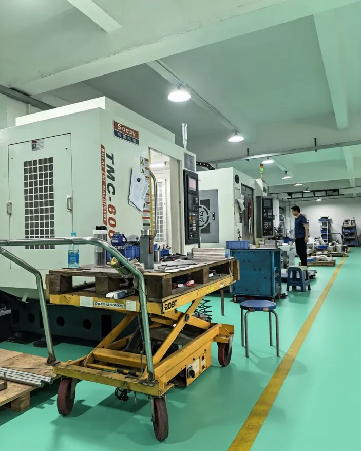 Machining bay at the SRX workshop with CNC equipment and work in progress
