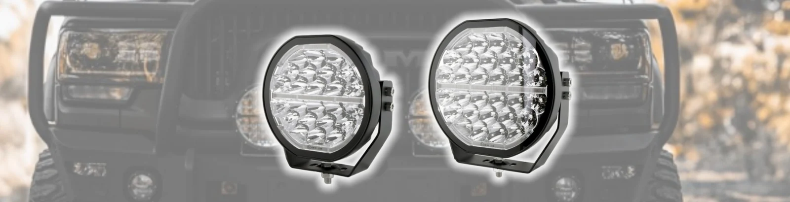 Pair of Sunlitec round LED work lights mounted on a vehicle front bumper