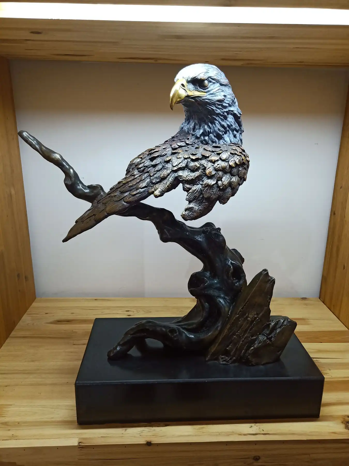 Hand-cast copper eagle sculpture in a museum exhibition hall