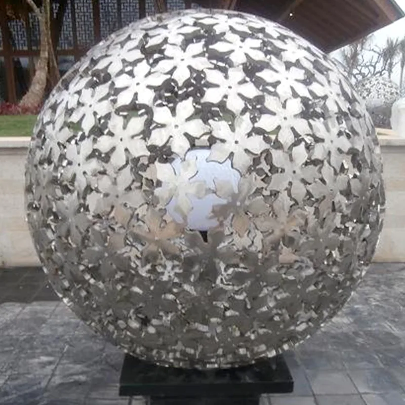 Mirror polished stainless steel hollow ball on a floor in a modern interior space