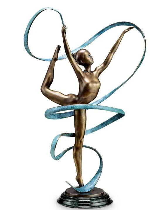 Cast copper sculpture of a dancing man on a wooden desk