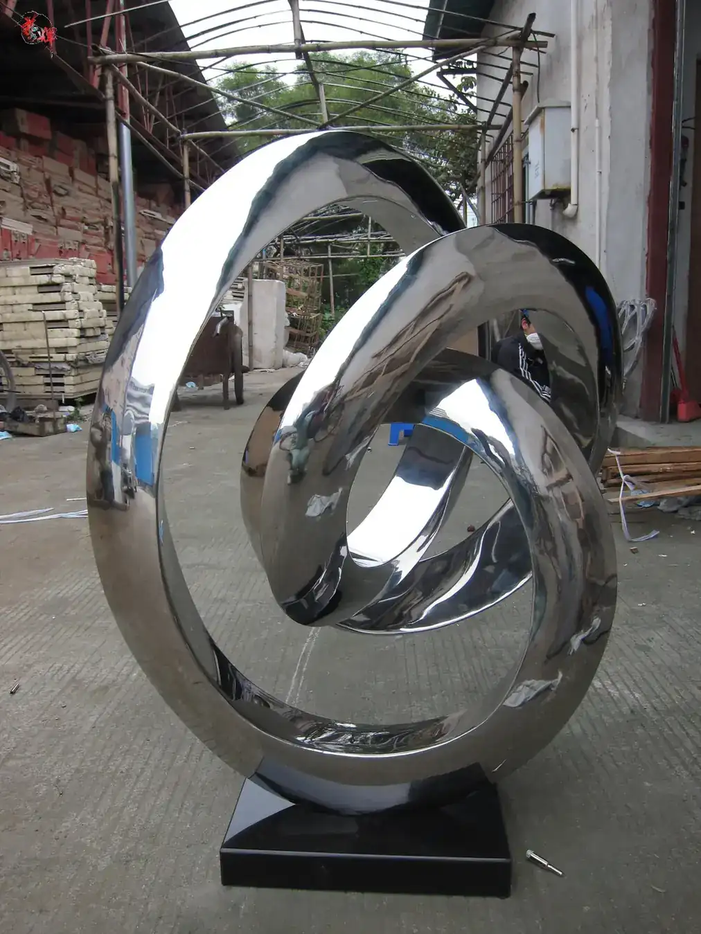 Abstract ribbon sculpture in mirror polished 304 stainless steel, flowing through space