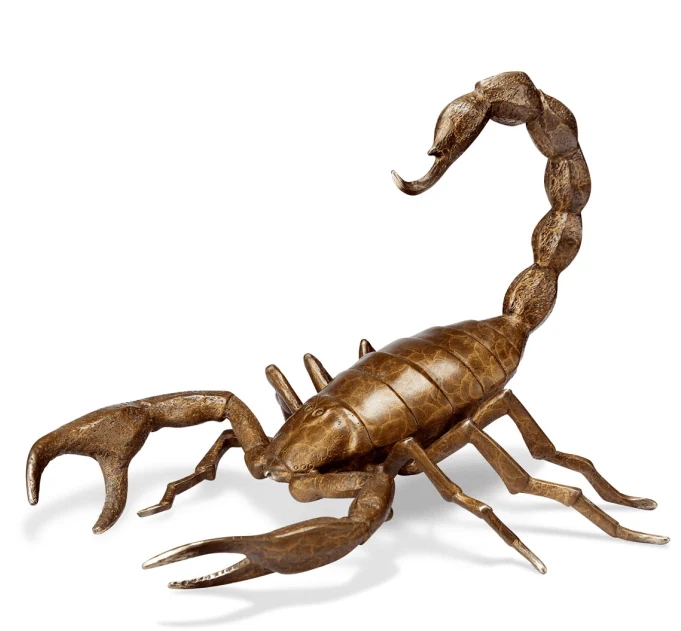 Brass cast scorpion sculpture on a wooden display table