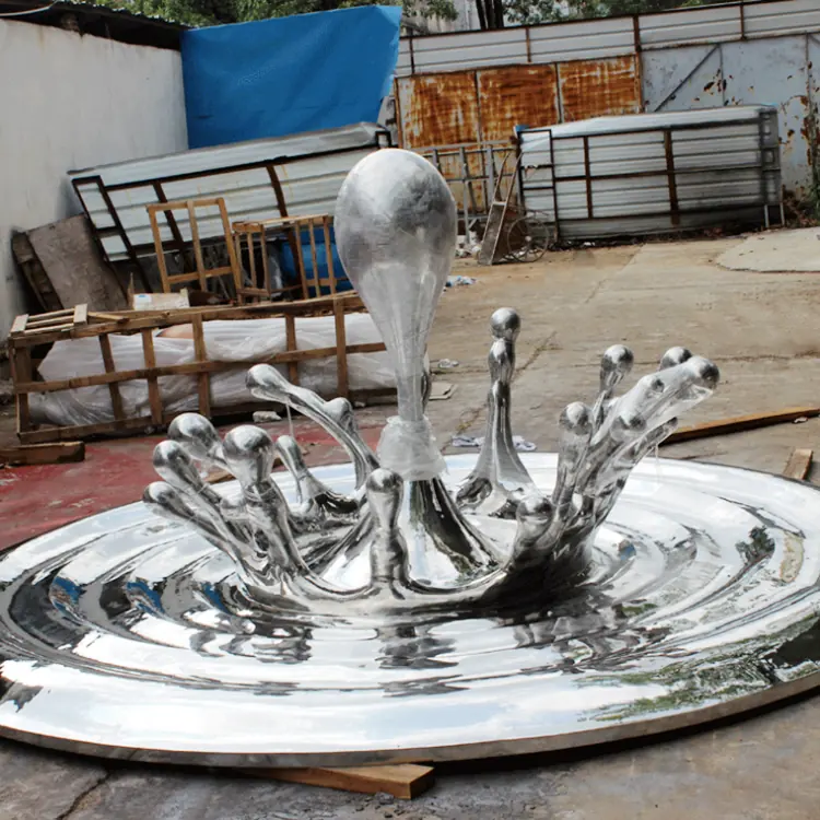 Stainless steel sculpture of water droplets and flowers in a flowing arrangement