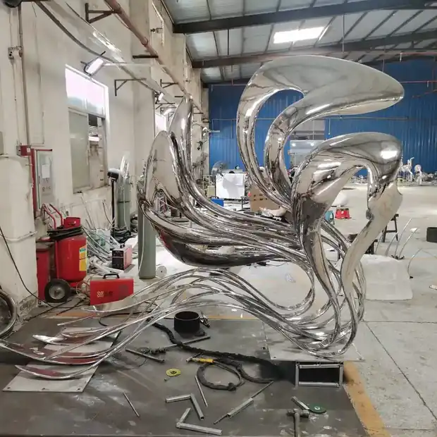 Abstract sculpture with brushed satin finish in an exhibition hall space