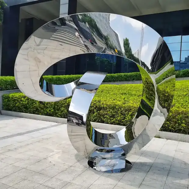 Close-up of hand forged stainless steel sculpture with polished surface and welded seams